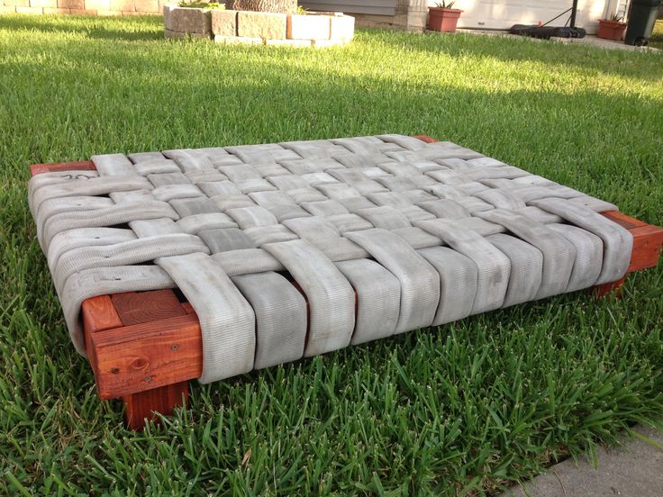 an outdoor bench made out of concrete blocks in the grass