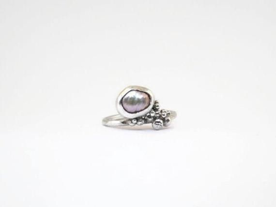 PEARL RING in sterling silver, Gift for her,Pearl engagement ring, Vintage engagement ring, Unique engagement ring, Art deco engagement ring Freeform shaped pearl in a sterling silver ring with small dots of sterling silver. This is a one of a kind handmade ring. The pearl is approximately 6 mm x 7mm June birthstone the ring size is for US 7 here is online ring size converter http://www.ringsizes.co/ Do not hesitate to contact me on Instagram as well: https://www.instagram.com/atelier_tiuh/ Unique Sterling Silver Pearl Promise Ring, Unique Silver Pearl Ring For Anniversary, Unique Sterling Silver Pearl Ring For Wedding, Unique Silver Pearl Promise Ring, Silver Pearl Drop Ring For Anniversary, Silver Rings With Pearl Drop In Fine Jewelry Style, Silver Sterling Silver Ring With Pearl Drop, Sterling Silver Rings With Pearl Drop In Silver, Unique Pearl Ring For Anniversary