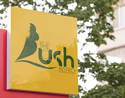 the bush bistro sign is displayed in front of a building with trees behind it