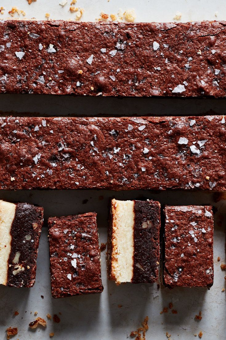 several pieces of chocolate cake sitting on top of a white countertop next to each other