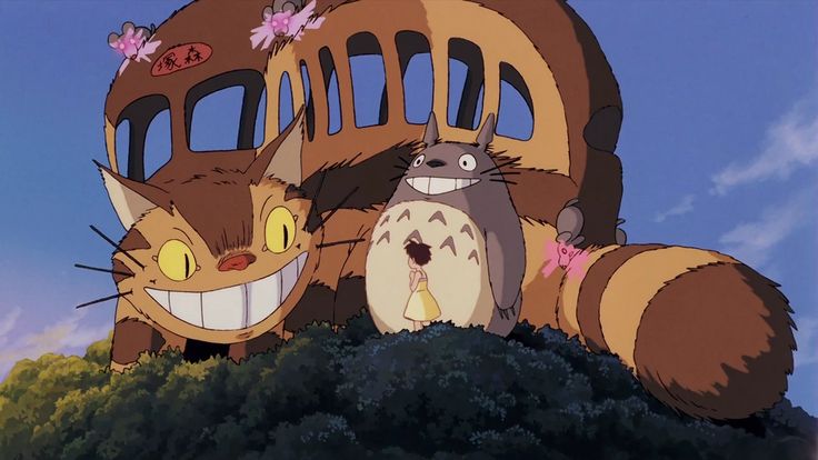 two cartoon characters are standing in front of a giant building with an owl and cat face on it