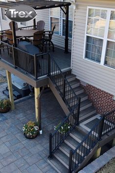 an outdoor patio with stairs leading up to the deck