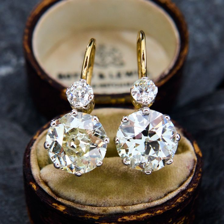 These dazzling platinum topped 18K yellow gold earrings are each accented with one (1) old European cut diamond set into an eight-prong platinum setting and one (1) old European cut diamond set into a four-prong platinum setting. The earrings measure 24.3mm X 10.9mm and are finished with 14K yellow gold lever style backs. They are simply perfect. Luxury Classic Cut Diamond Jewelry, Luxury Refined Brilliant Cut Jewelry, Luxury Antique Diamond Earrings, Luxury Estate Engagement Jewelry, Traditional Luxury Earrings With Prong Setting, Luxury Antique Diamond Earrings For Anniversary, Luxury Gold Heirloom Diamond Earrings, Luxury Antique Brilliant Cut Diamond Earrings, Luxury Dazzling Gemstones With Prong Setting