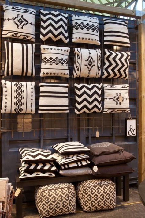 black and white pillows on display in a store