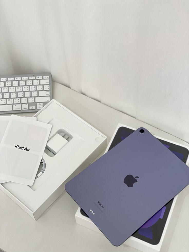 an apple ipad is sitting on top of a box next to a keyboard and mouse