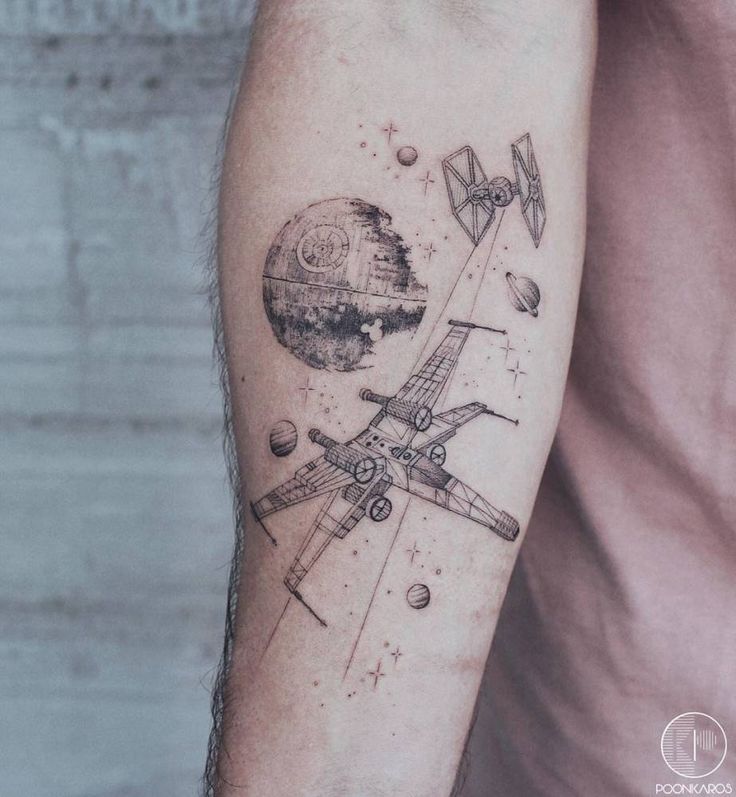 a man with a tattoo on his arm that has an airplane flying over the earth