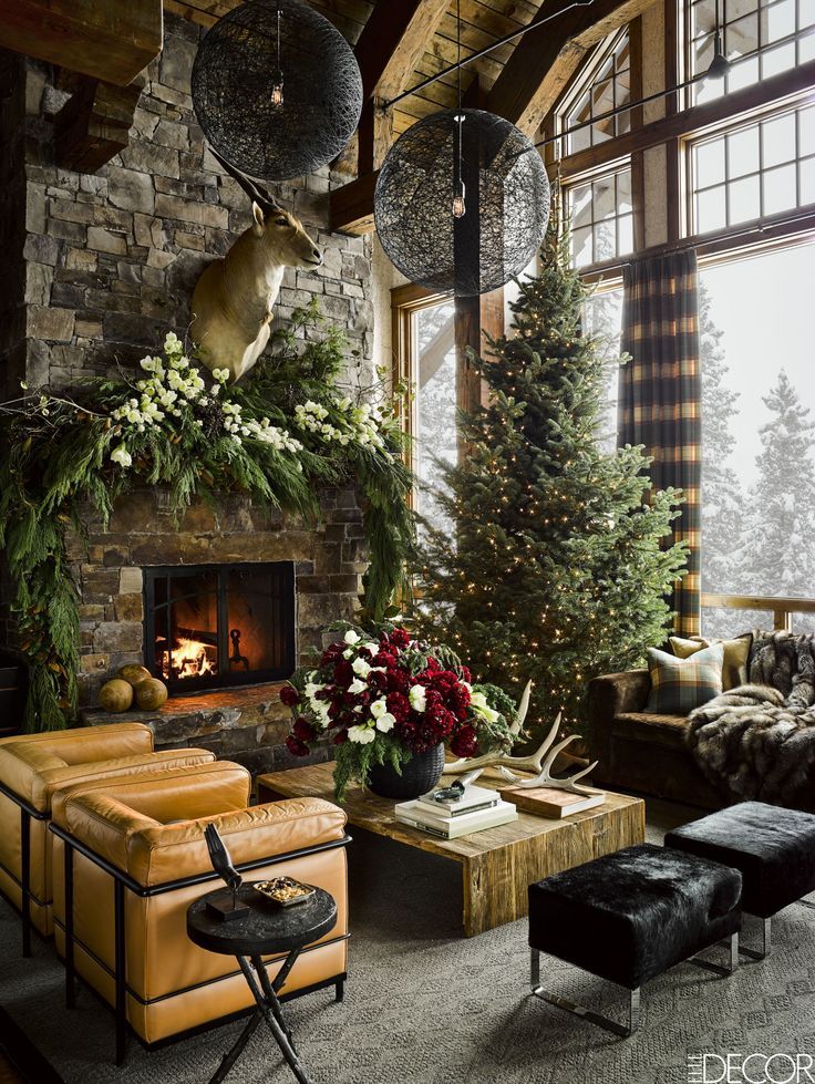 a living room filled with furniture and a fire place covered in christmas tree garlands