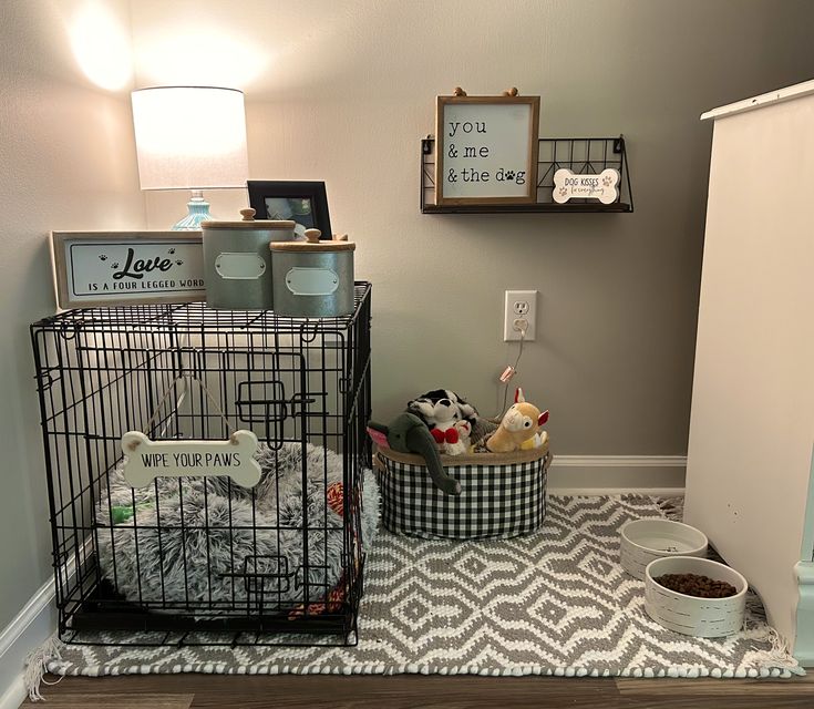 a cage with some stuffed animals in it on the floor next to a lamp and pictures