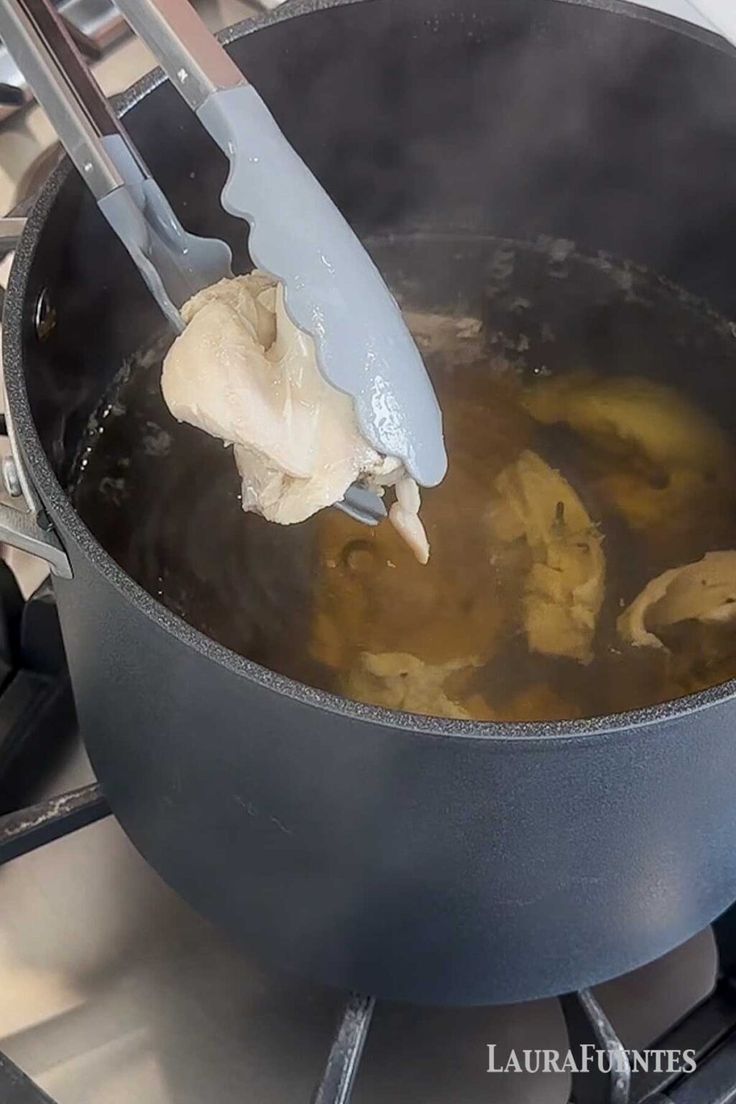 a pan with some food cooking on top of it and a spatula in the middle