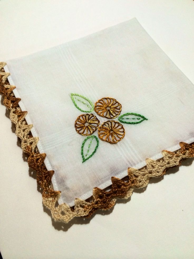 a white cloth with green leaves on it