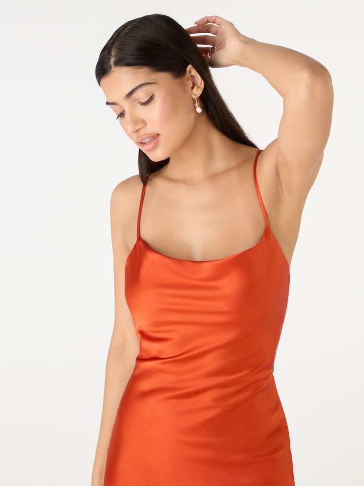 Our best-selling Riviera in heatwave Brick Orange. Inspired by 90s slip dresses, with a flattering body-skimming cut, cowl neck and show-stopping tie back detail. Expertly crafted from 100% satin-feel Recycled Polyester. We’ve designed the Riviera with longevity and sustainability in mind, she's about to become your new favourite item in your wardrobe. Cowl Neck Slip Dress For Night Out In Summer, Summer Fitted Slip Dress With Cowl Back, Fitted Cowl Neck Slip Dress For Summer, Summer Silk Satin Dress With Cowl Back, Summer Date Night Slip Dress With Cowl Back, Summer Slip Dress For Date Night With Cowl Back, Fitted Satin Dress With Tie Back For Summer, Fitted Tie-back Satin Dress For Summer, Spring Fitted Slip Dress With Cowl Back