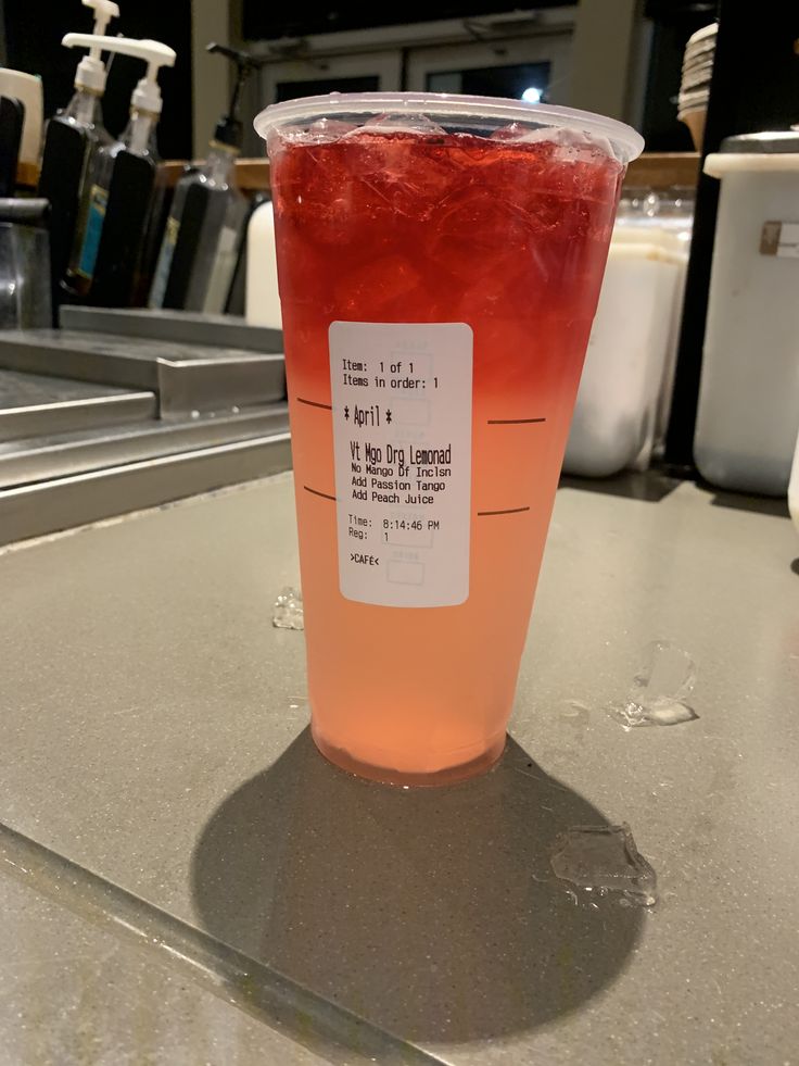 a plastic cup filled with liquid sitting on top of a counter