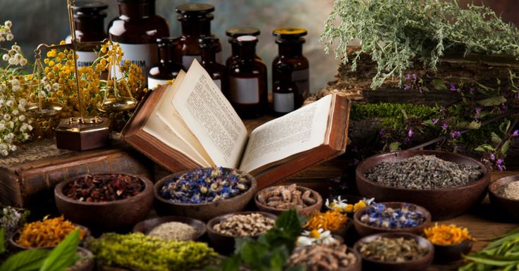 an open book surrounded by herbs and other items on a table with the words green revolution written in it