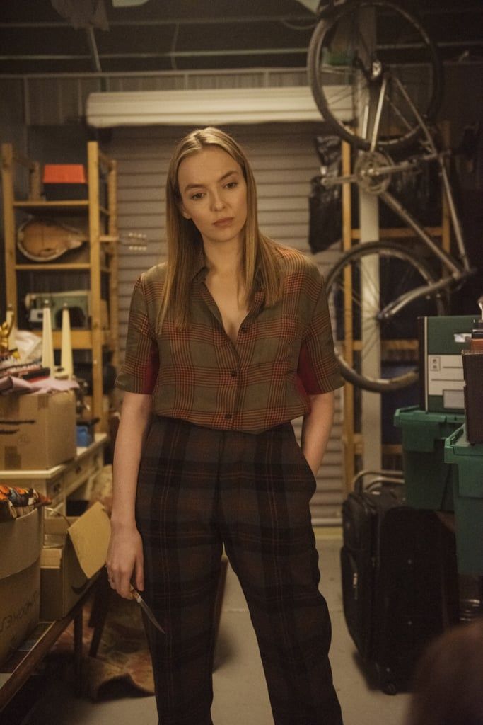 a woman standing next to a bike in a garage