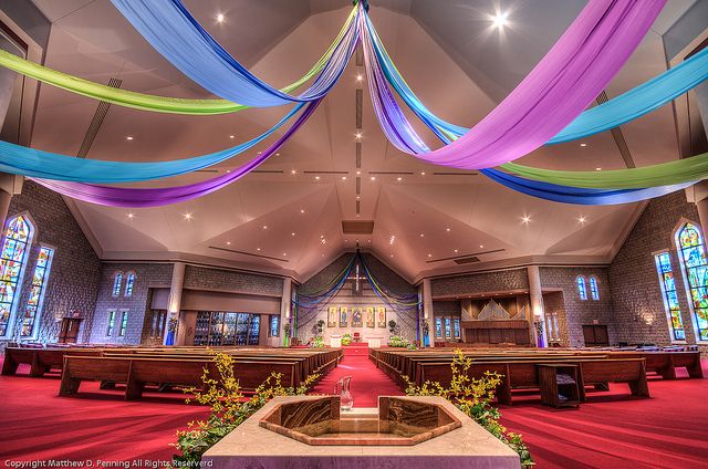 the interior of a church decorated with colorful streamers