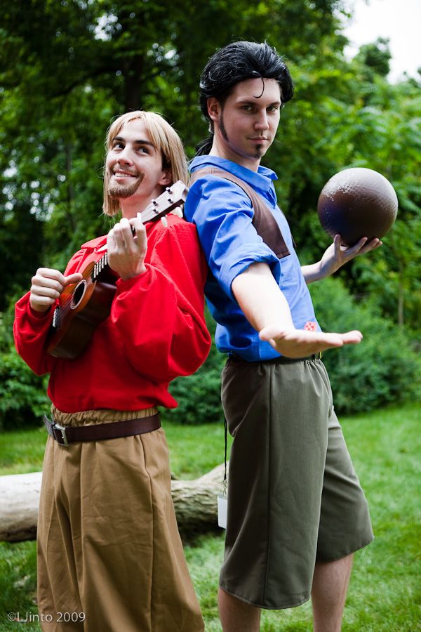 two people dressed up in costumes and one is holding a ball