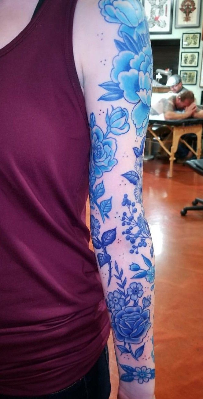 a woman with blue flowers on her arm