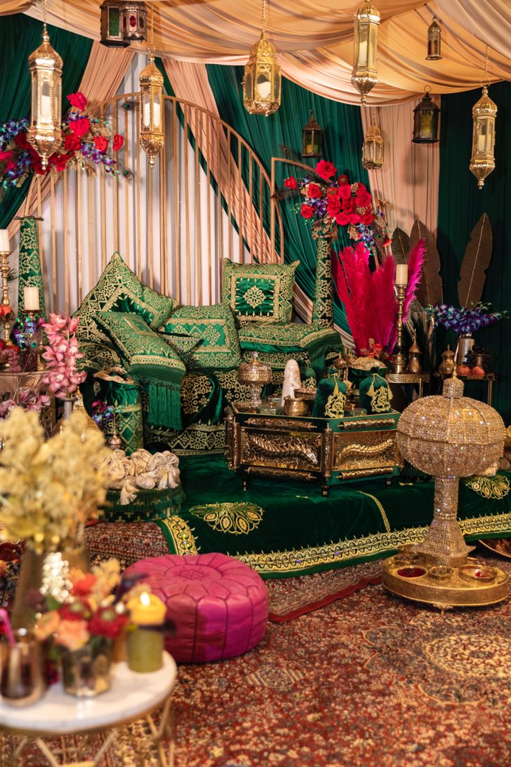 a living room filled with lots of green furniture