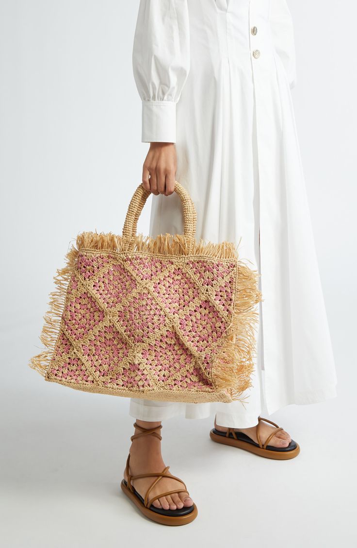 A granny-square design edged with fringe brings retro appeal to this basket-inspired tote crocheted from two-tone raffia. Open top Top carry handles Raffia Imported Designer Handbags Black Owned/Founded Spring Rectangular Straw Bag With Tassels, Natural Crochet Bag With Intrecciato Weave For Shopping, Rectangular Straw Bag With Intrecciato Weave, Beach Crochet Bag With Intrecciato Weave In Straw, Beige Crochet Bag With Intrecciato Weave For Beach, Rectangular Straw Bag With Fringe, Shopping Tote Straw Bag With Fringe, Summer Straw Bag With Intrecciato Weave And Double Handle, Straw Crochet Bag With Intrecciato Weave For Shopping