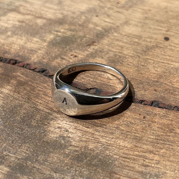 Make it personal... A classic small circle signet ring hand-stamped with your desired initial. Simply enter the letter of your choice in the order notes. These timeless signet rings are meticulously crafted by hand in our Melbourne workshop, created out of wax and then cast into precious metal. Made with the highest quality Australian sterling silver to last forever. Made solid, not hollow like many others, all of our rings are hand-stamped with a Sterling Silver (925) hallmark and Custom Creed Timeless Everyday Initial Ring, Everyday Timeless Sterling Silver Engraved Ring, Everyday Silver Signet Ring With Engraving Option, Sterling Silver Initial Ring For Everyday, Everyday Engraved Dome Ring, Personalized Timeless Rings For Everyday, Adjustable Hand Stamped Initial Ring Minimalist, Adjustable Hand Stamped Minimalist Initial Ring, Timeless Personalized Rings