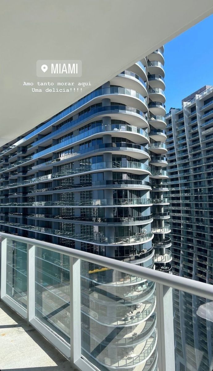 an apartment building with balconies and glass railings