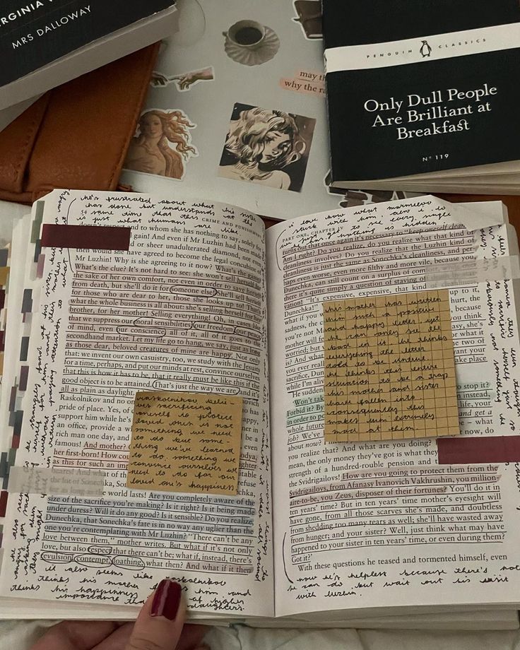 an open book with writing on it and several other books in the background that are stacked together