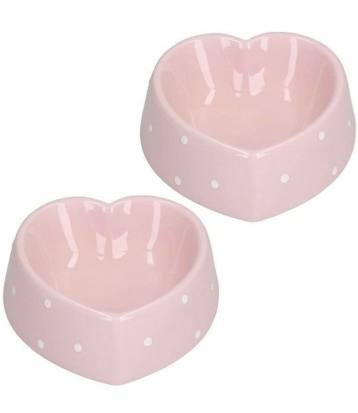 two pink heart shaped bowls with white polka dots on the bottom and one in the shape of a heart