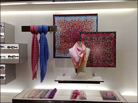 a display case filled with different types of scarves