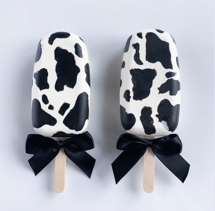 two pops with black and white cow print on them