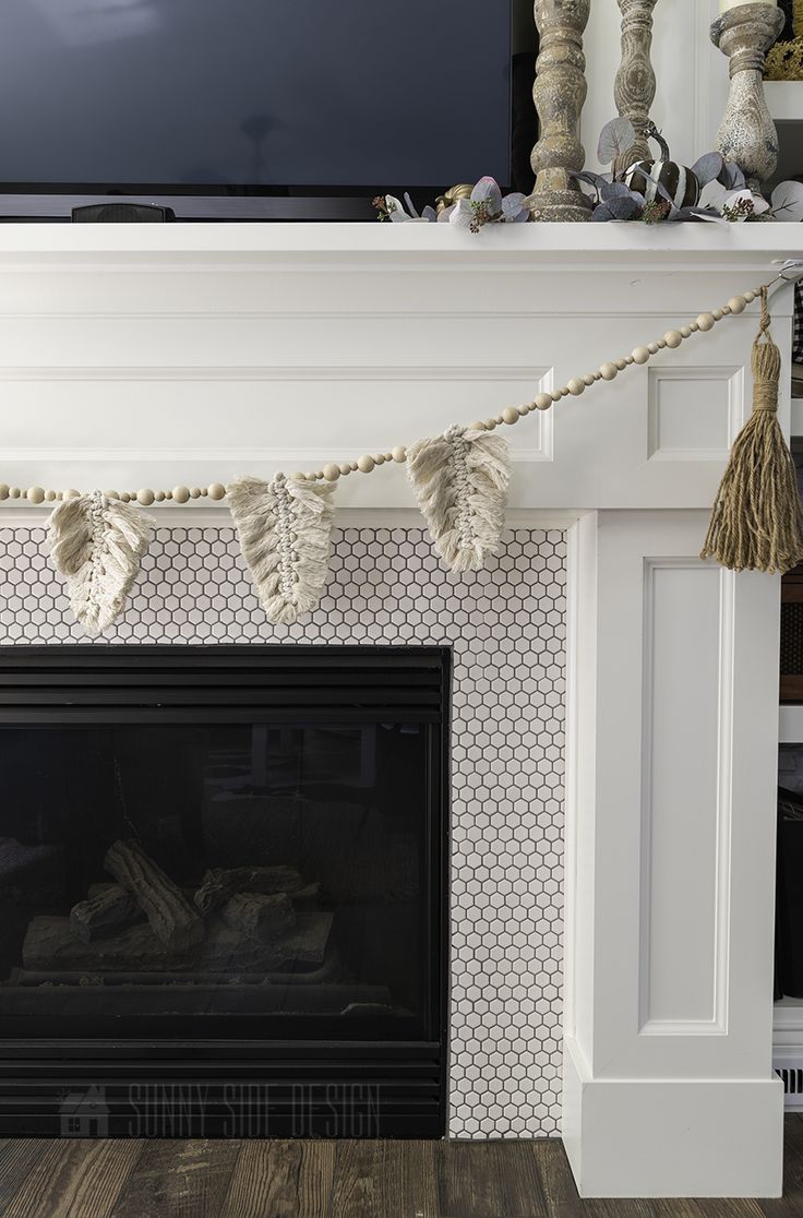 a fireplace with a tv above it and some decorations on the mantle