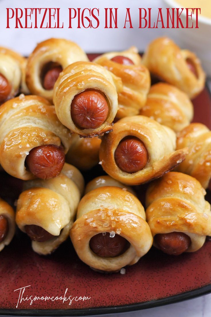 there are many hot dogs wrapped in bread on the plate and ready to be eaten