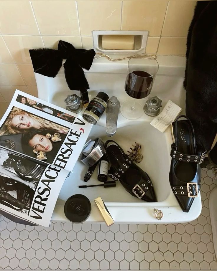 a bathroom sink filled with assorted women's shoes and cosmetics on top of it