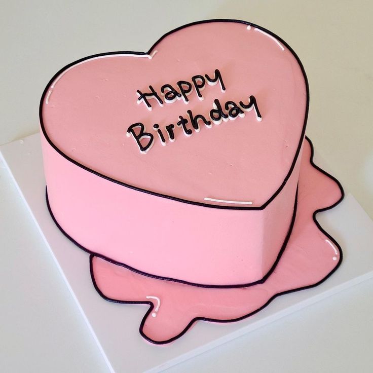 a pink heart shaped cake with the words happy birthday written on it's side