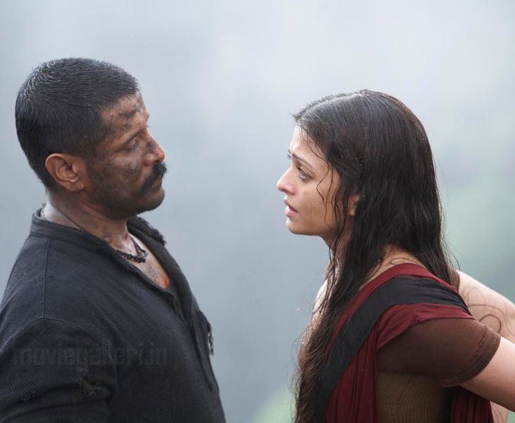 a man and woman standing next to each other in front of a foggy sky