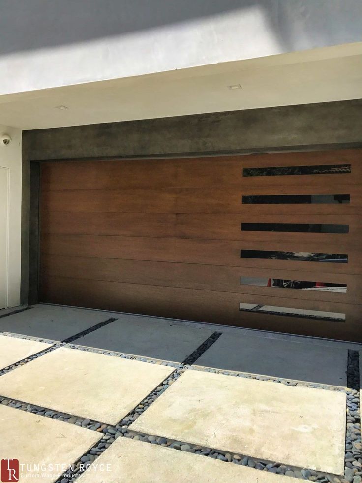 a modern garage door is shown in front of a house with tile flooring and white walls