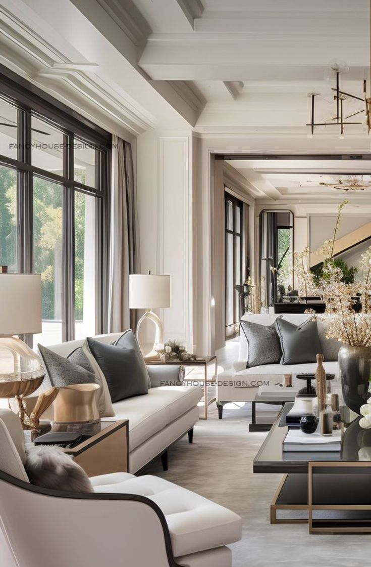 a living room filled with lots of furniture and large windows in the wall behind it