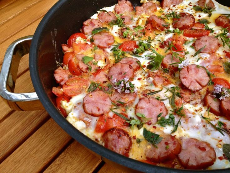 a pan filled with lots of food on top of a wooden table