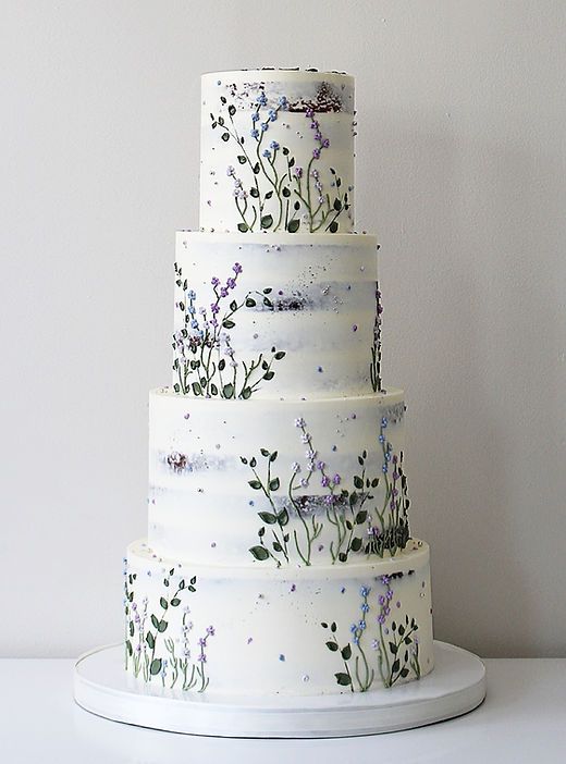 a three tiered cake with flowers painted on it