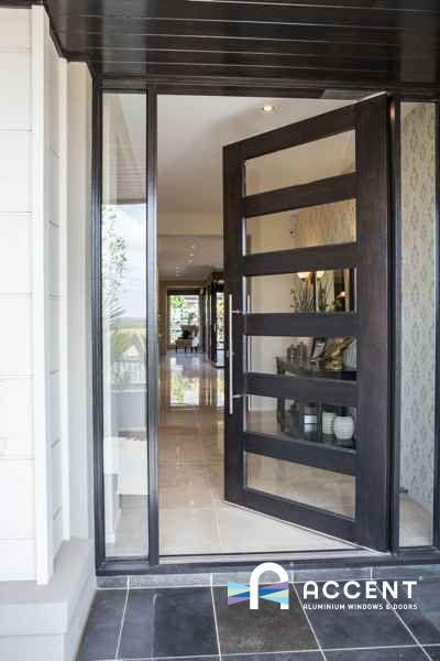 an image of a door with glass and wood in the front entrance to a house