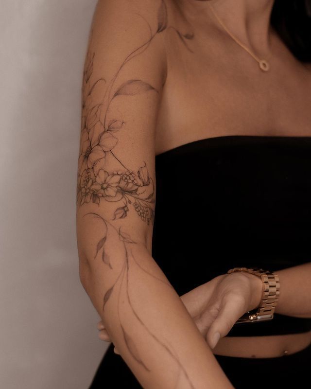 a woman with tattoos on her arm