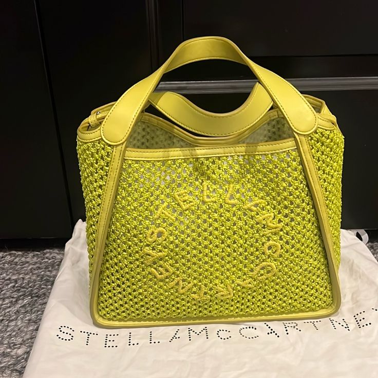 Lime Green Stella Mccartney Raffia Tote Bag With Two Short Top Handles And One Crossbody Strap. Featuring Woven Raffia Design With Mesh Detailing, Embroidered Logo On The Front, Two Flat Top Handles, Faux-Leather Trim, Detachable Shoulder Strap, Open Top, Removable Pouch, And Unlined. Brand New Never Worn, Comes With Tags And Dust Cover. Designer Summer Bags With Intrecciato Weave, Designer Bags With Intrecciato Weave For Summer, Designer Summer Straw Bag, Designer Straw Bag For Summer, Designer Green Summer Bag, Designer Green Summer Bags, Designer Green Bags For Summer, Designer Straw Bag With Woven Leather Details, Luxury Summer Straw Bag With Intrecciato Weave