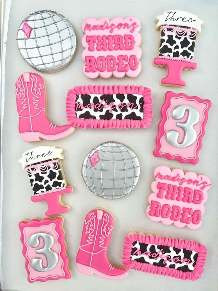 decorated cookies in the shape of numbers and hairbrushes