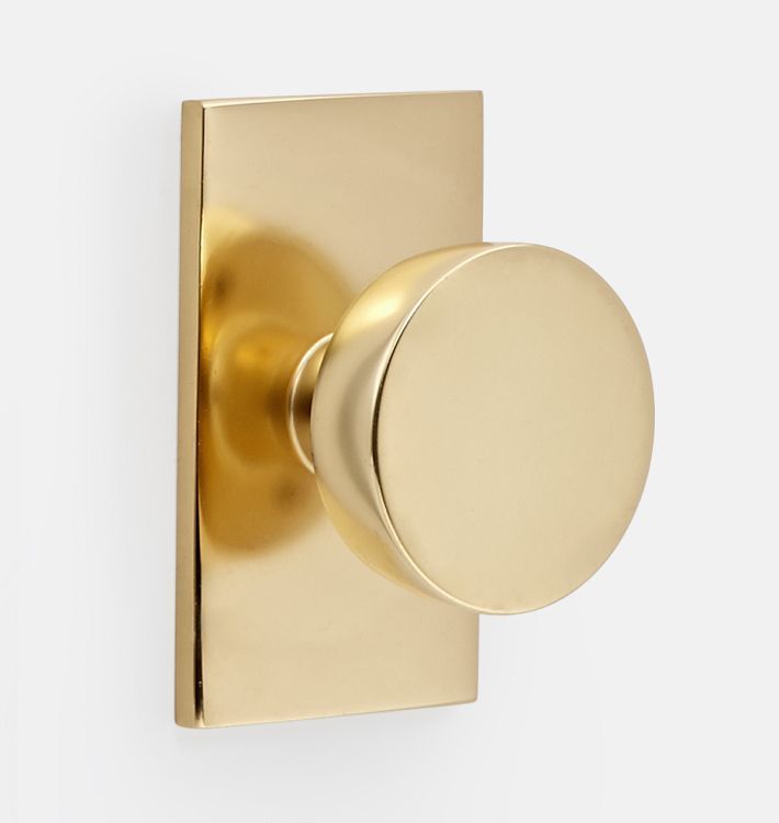 a gold door knob on a white wall