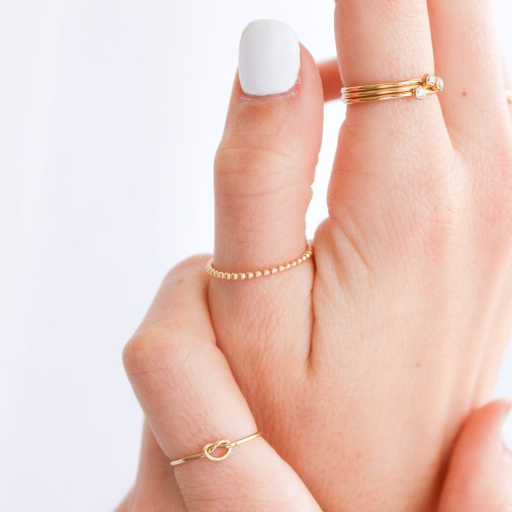 Dainty and delicate, the Love Me Knot Ring is one of the sweetest additions to our stacking kellection. Made to remember the ties to our loved ones, this beauty is the perfect gift for the special someone in your life or to permanently have your nearest and dearest close at hand. 14k Gold Filled Stackable Rings As Gift, Simple Design Gold Stackable Rings As Gift, 14k Gold Filled Dainty Everyday Rings, Dainty 14k Gold Filled Rings For Everyday, Delicate Hypoallergenic 14k Gold Midi Rings, Gold Filled Stackable Open Rings For Gifts, 14k Gold Filled Midi Rings With Simple Design, Dainty Hypoallergenic 14k Gold Filled Rings, Adjustable 14k Gold Midi Rings For Everyday