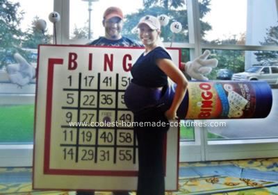 a man and woman are standing in front of a sign with a game on it