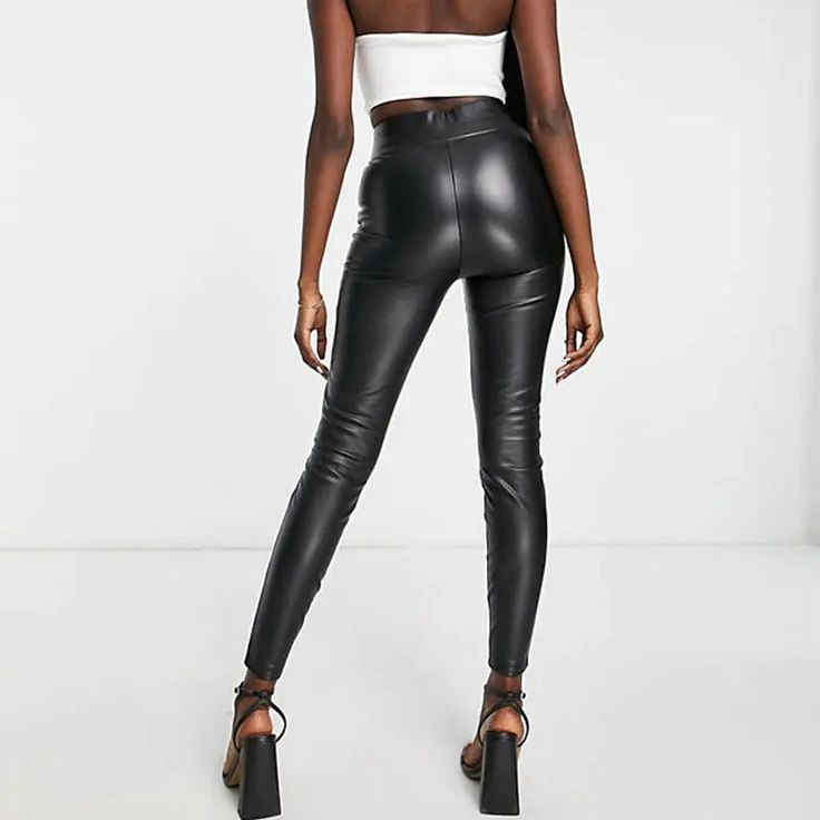 Discover the essence of sleek and modern style with our Sleek High-Waist Stretch Pencil Trousers. These trousers are a perfect blend of casual elegance and comfortable wear, suitable for all seasons. The high waist design not only adds a touch of sophistication but also provides a flattering fit for various body types. Crafted with a medium stretch fabric, these trousers ensure both comfort and a figure-hugging silhouette. The PU faux leather material, combined with spandex, offers a luxurious feel and a flexible fit, making these trousers ideal for day-long wear. Featuring a solid pattern and a classic pencil pant style, these trousers are a versatile addition to your wardrobe. Whether it's a day at the office or a casual evening out, these trousers adapt effortlessly to any setting. The Modern Leather Trousers For Night Out, Sleek Leather Pants For Going Out, Sleek High Waist Fitted Leggings, Fitted Modern Leather Pants, Sleek High Waist Leggings, Modern Straight Leather Pants, Chic Tapered Leg Leather Pants, Tight Tapered Leggings, Modern High Waist Black Leather Pants