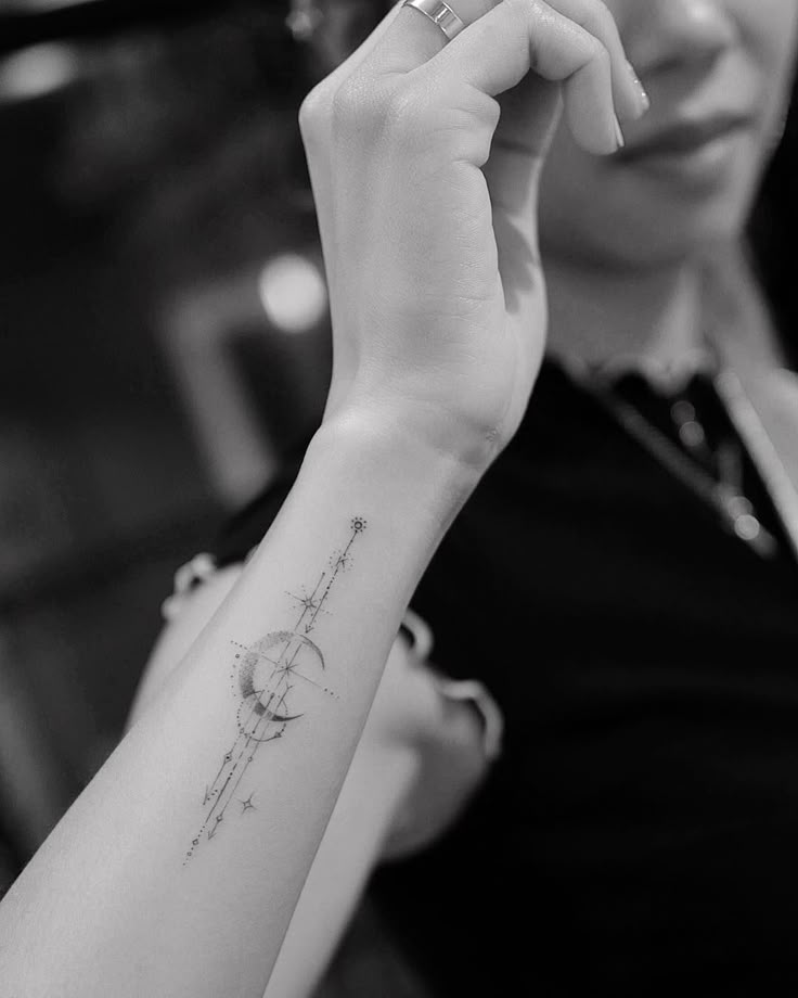 a woman with a small tattoo on her arm