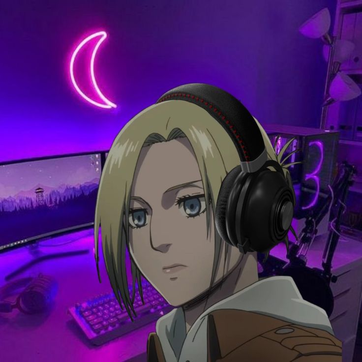 an anime character with headphones on in front of a computer monitor and keyboard, looking at the camera