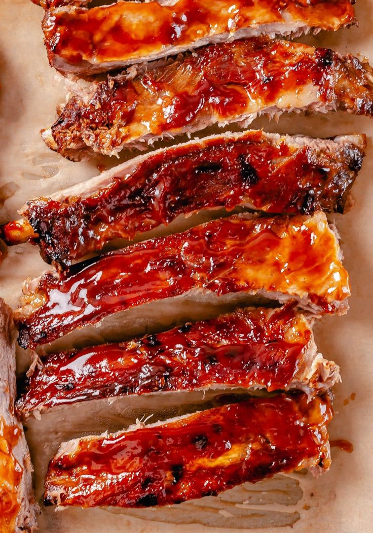 slices of ribs covered in bbq sauce