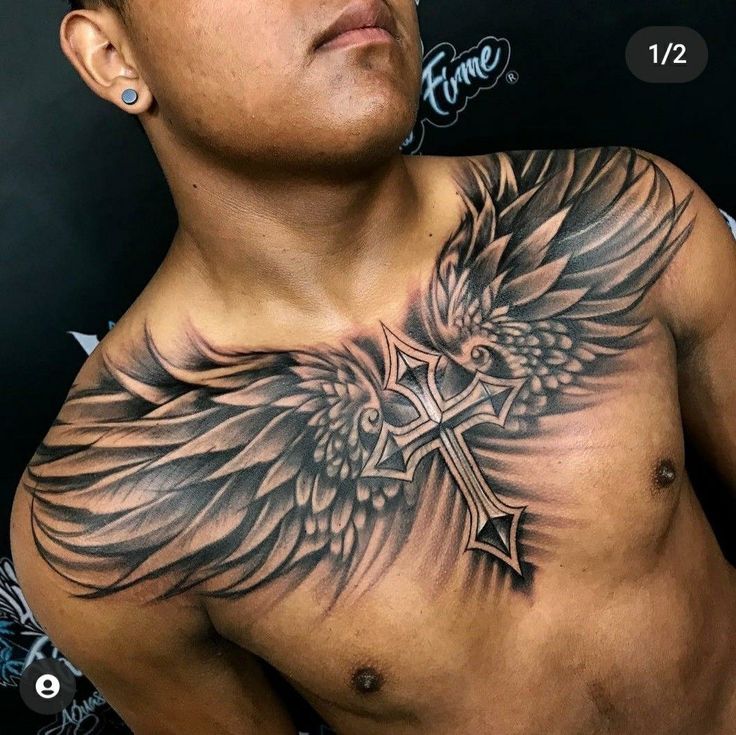 a man with a cross and wings tattoo on his chest